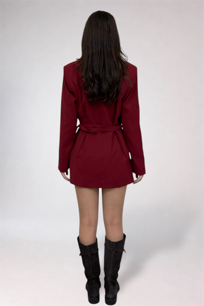 Person wearing a burgundy coat with a white background