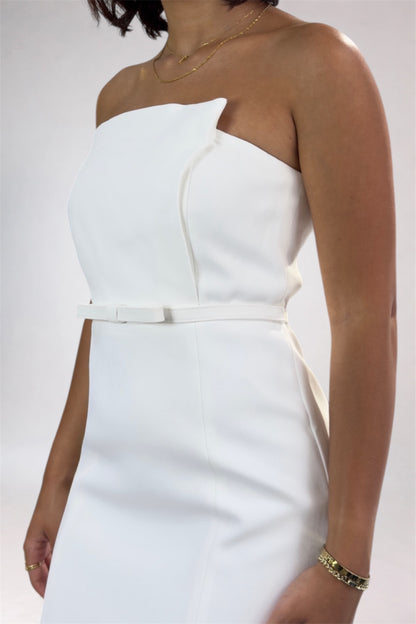 White strapless dress worn by a person on a white background