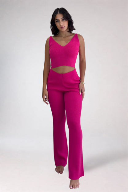 Woman wearing a bright pink outfit on a white background