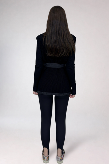 Person wearing a black jacket and pants on a white background