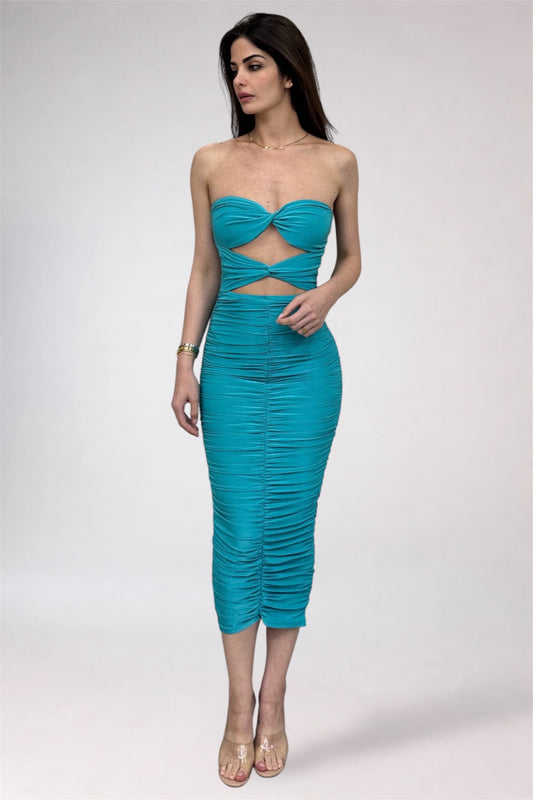 Woman wearing a turquoise strapless dress with cut-out design on a white background