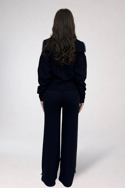 Person wearing a black outfit on a white background