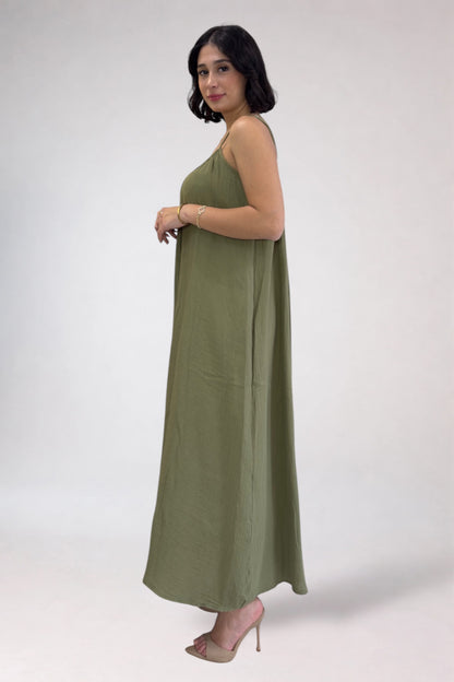 Woman wearing a long green dress on a white background