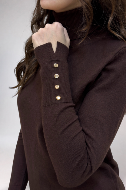 Brown sweater with button details on a plain background
