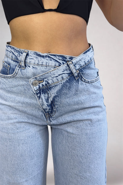 Light blue jeans worn by a person on a plain background