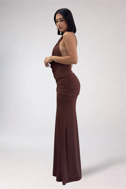 Woman wearing a brown halter neck dress on a white background