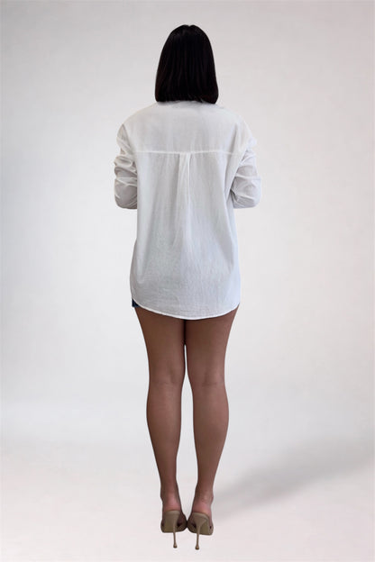 Person wearing a white shirt and black tights on a plain background