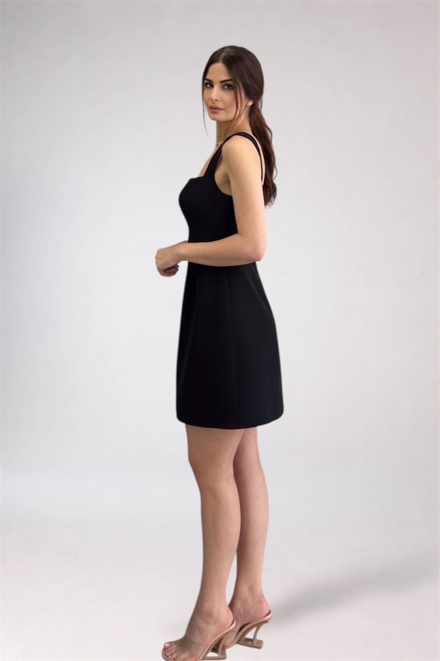 Woman wearing a black dress on a white background