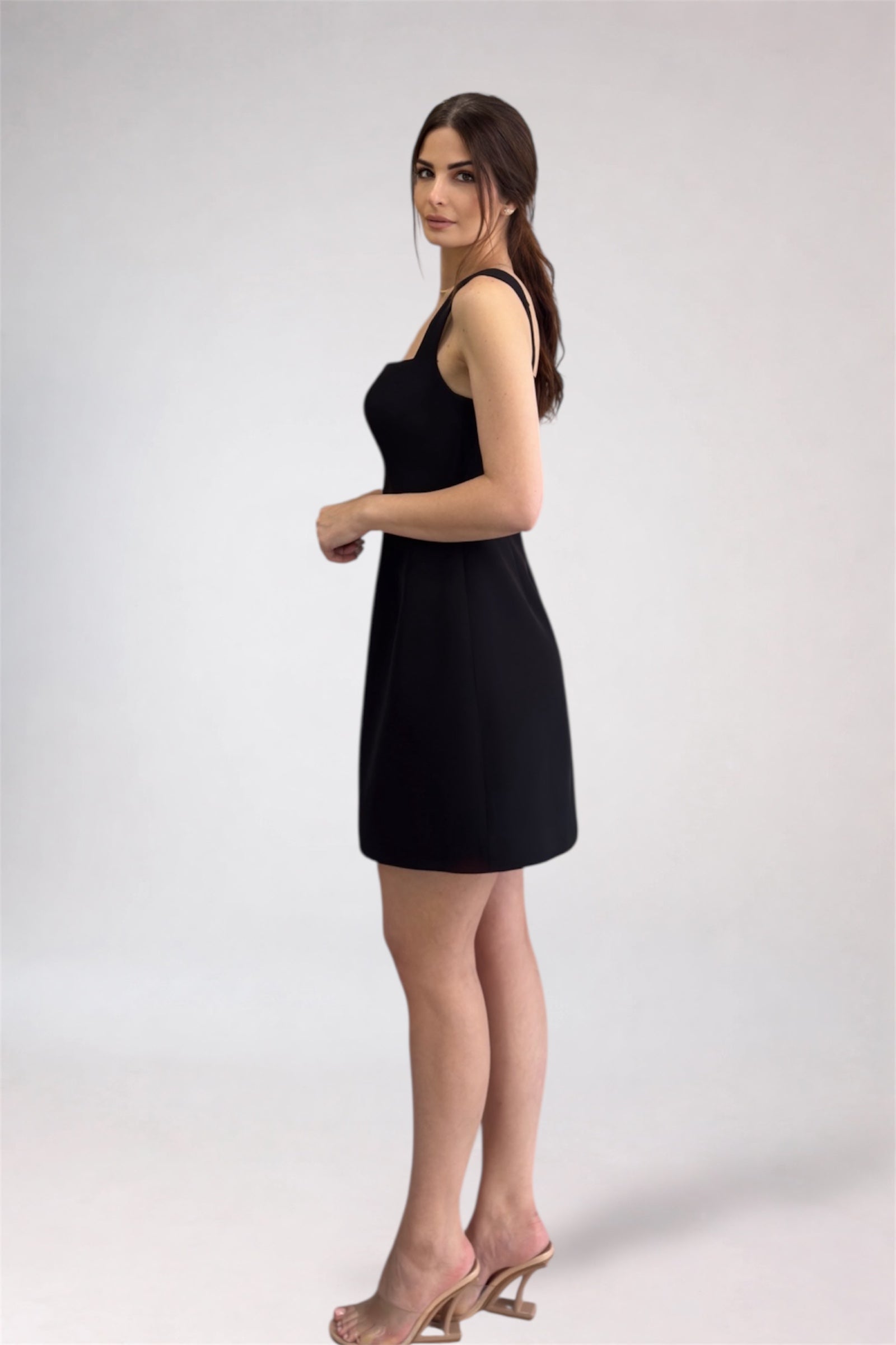 Woman wearing a black dress on a white background