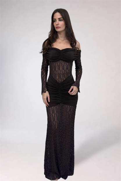 Woman wearing a black lace dress against a white background