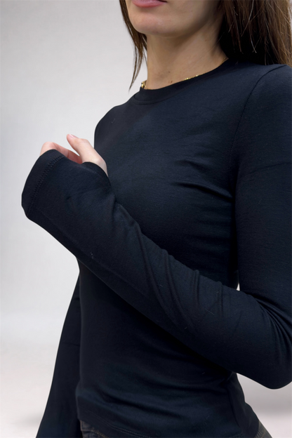 Person wearing a black long-sleeve shirt against a plain background