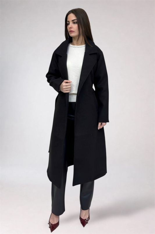 Woman wearing a black coat on a white background