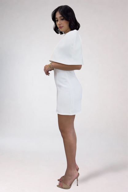 Woman wearing a white dress against a plain background