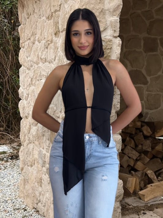 Black halter top with open back worn by a person in nature