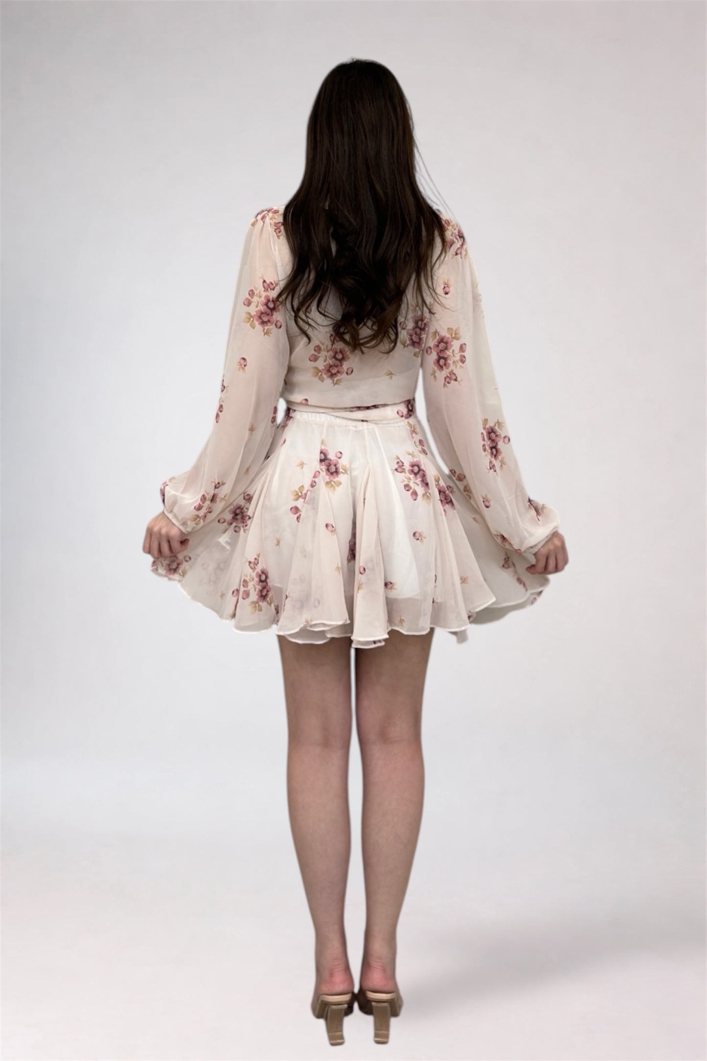 Woman wearing a floral dress on a white background
