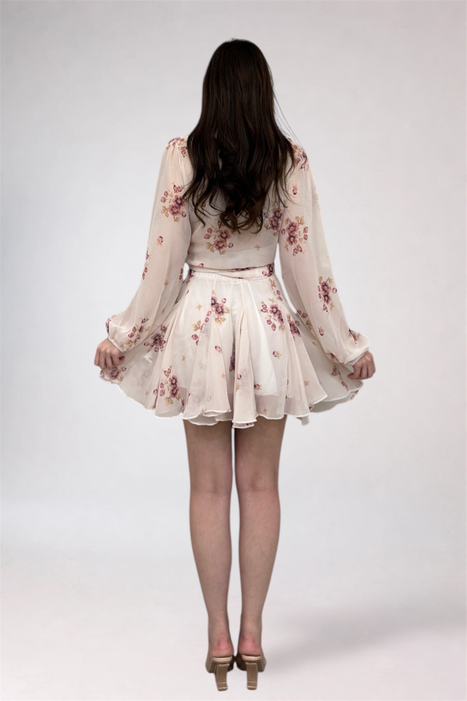 Woman wearing a floral dress on a white background