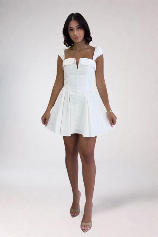 Woman wearing a white dress on a plain background