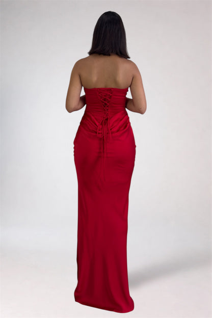 Woman wearing a strapless red evening gown on a white background