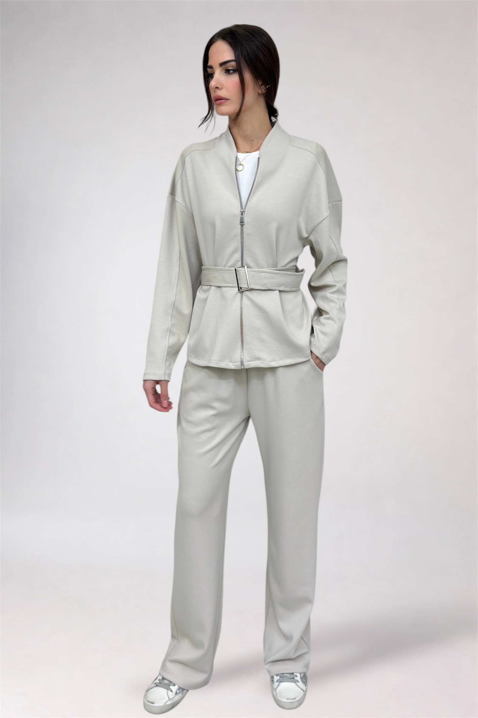 Woman wearing a light gray suit on a white background