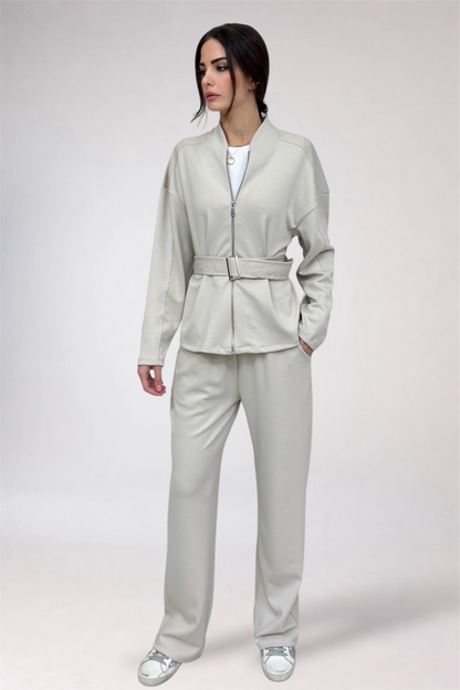 Woman wearing a light gray suit on a white background