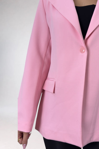 Pink blazer worn by a person on a white background
