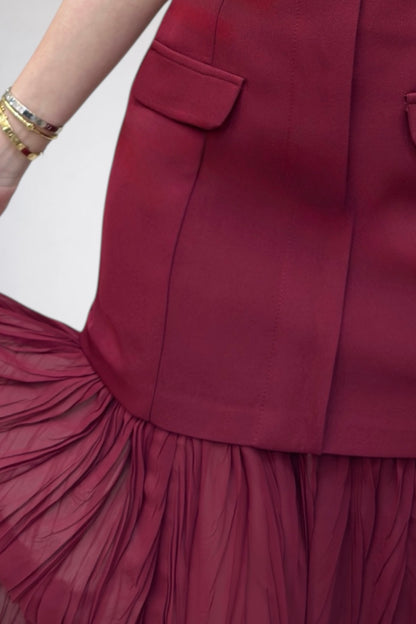 Close-up of a maroon skirt with a white background