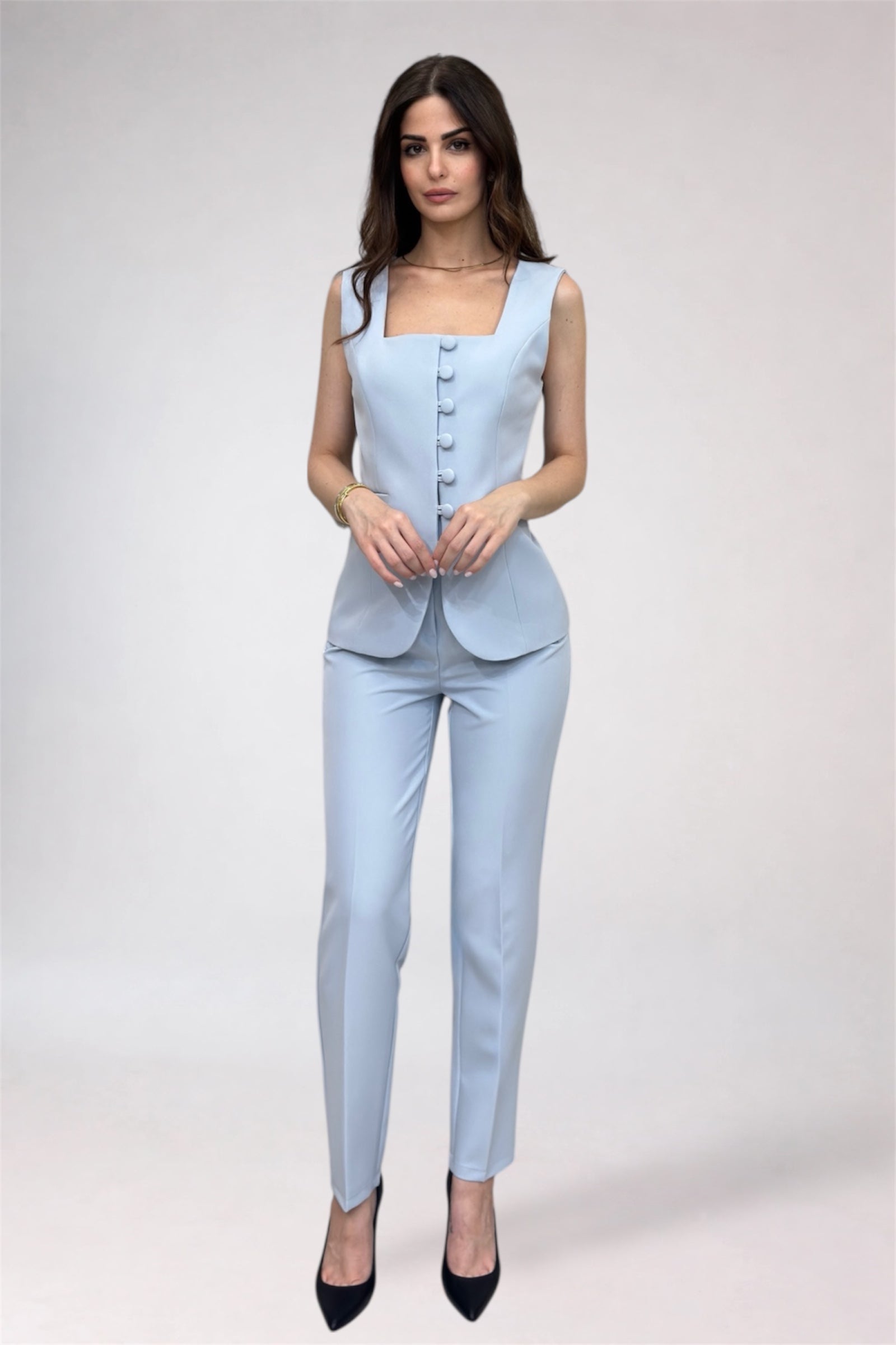 Woman wearing a light blue suit with a white background