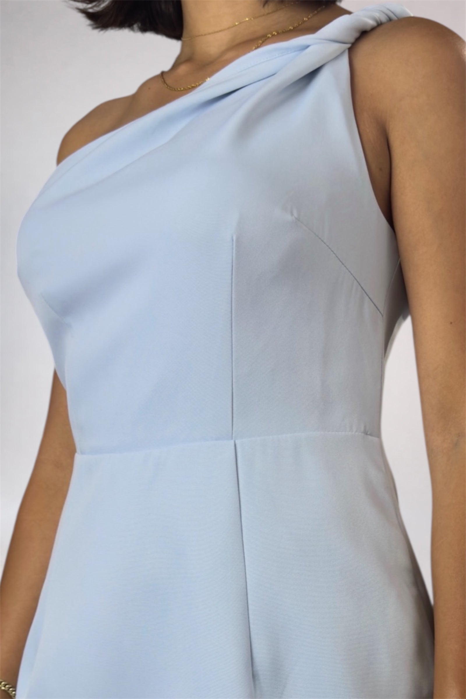 Light blue one-shoulder dress on a plain background