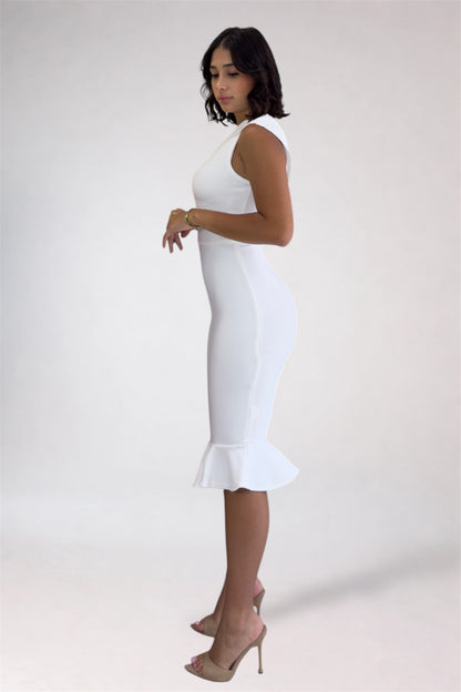 Woman wearing a white dress with a ruffled hem on a plain background