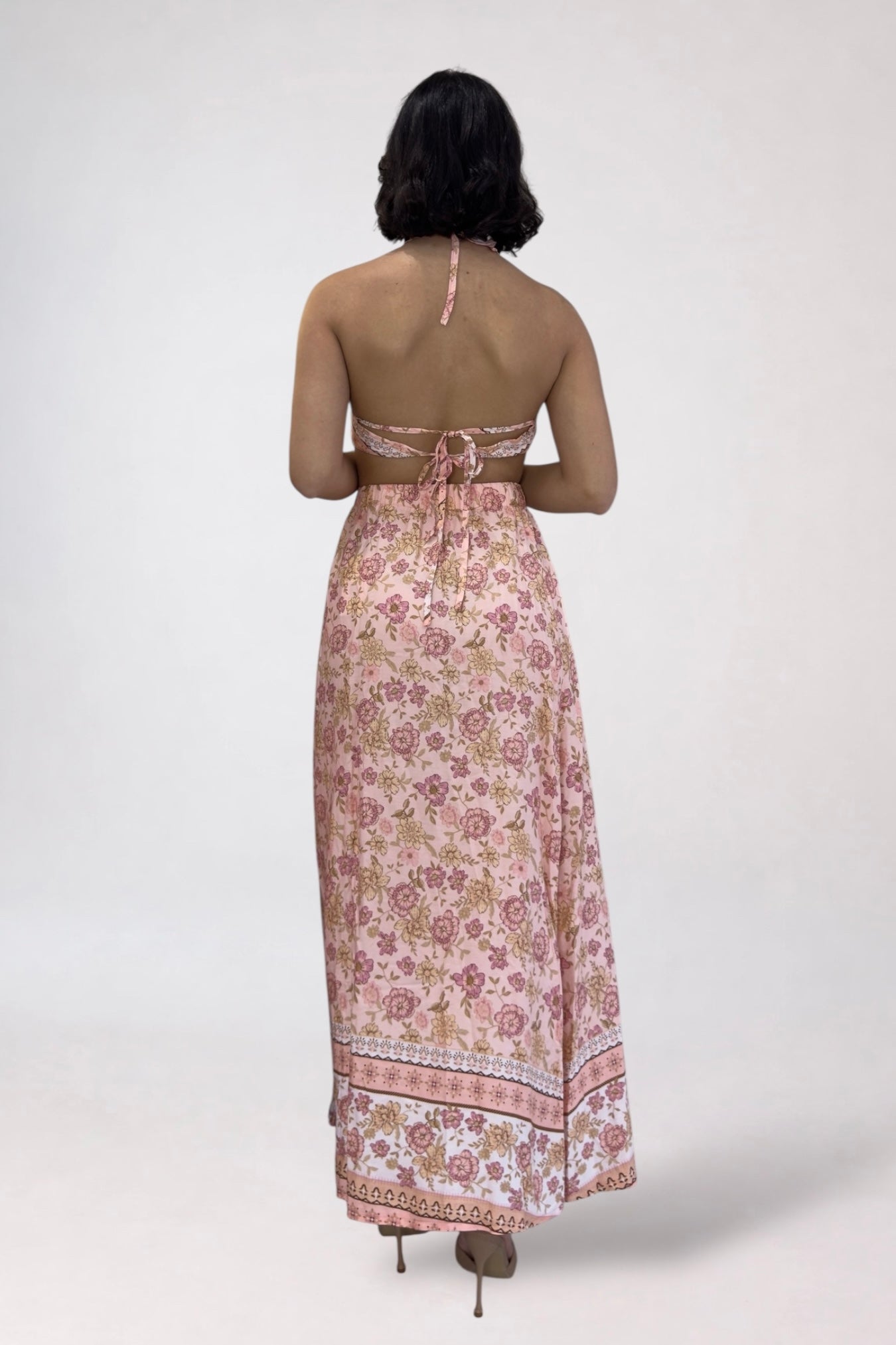 Woman wearing a floral dress with a white background