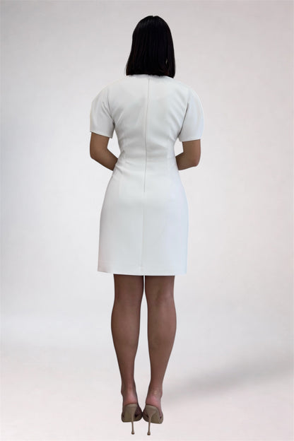 Person wearing a white dress on a plain background
