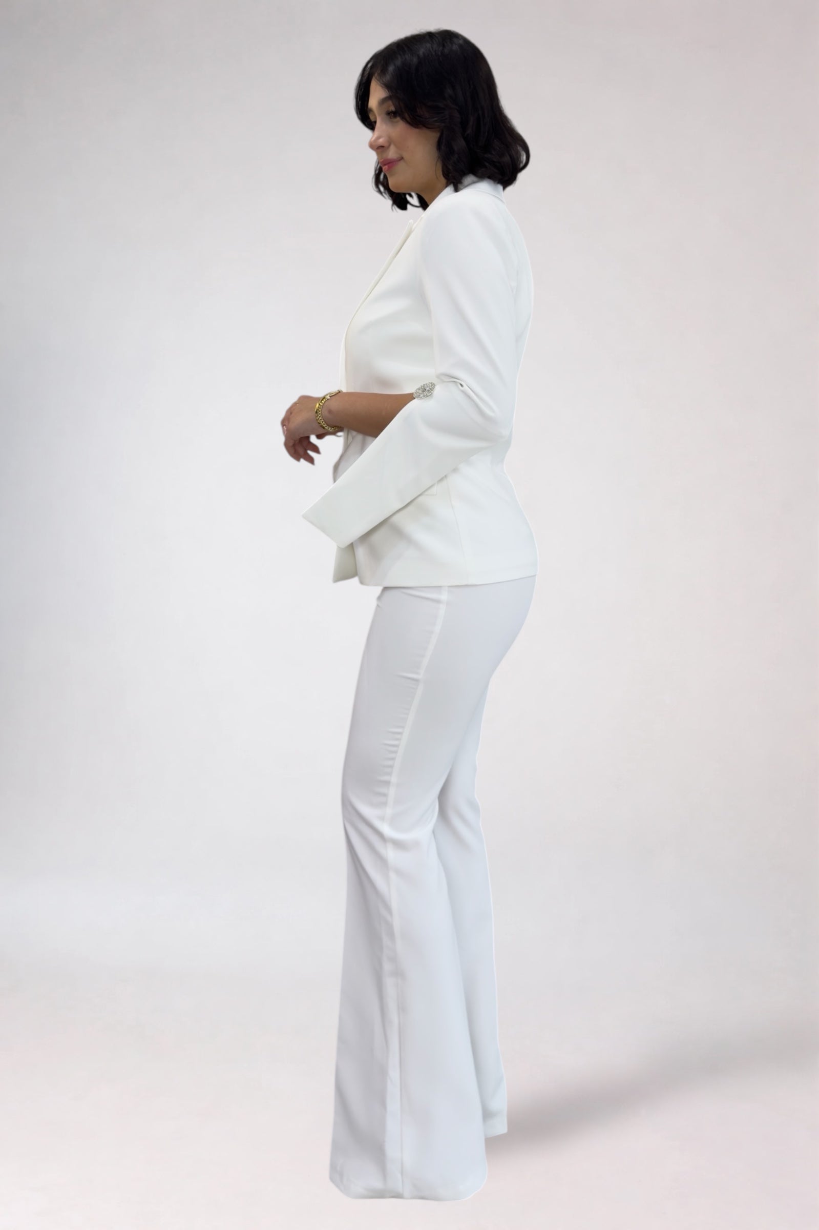 Person wearing a white outfit on a plain background
