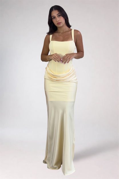 Woman wearing a yellow to white gradient dress on a white background