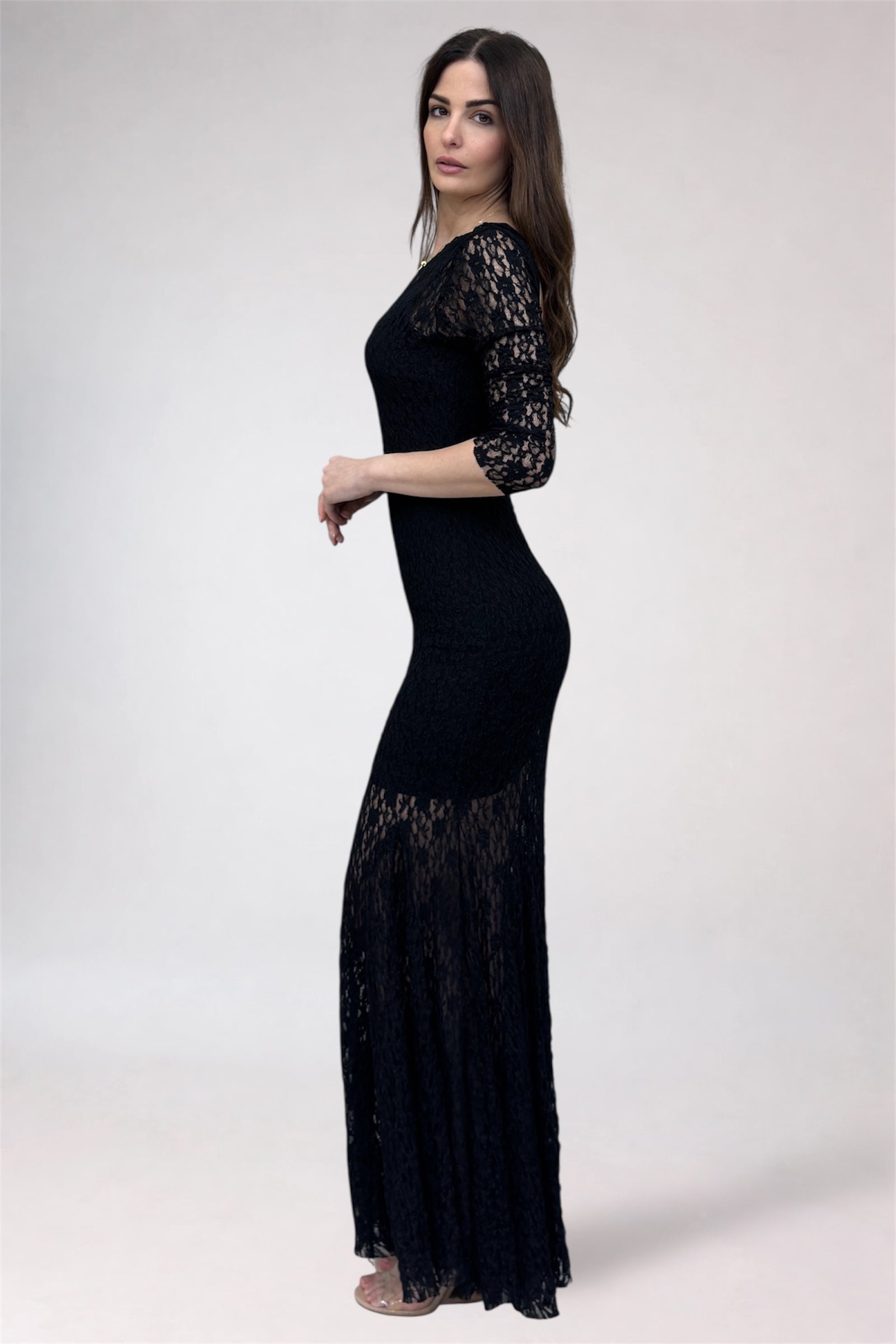 Woman wearing a black lace dress on a white background