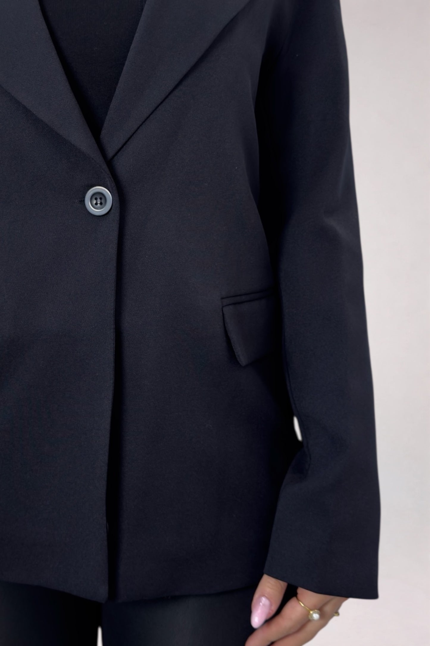 Navy blue blazer on a neutral background