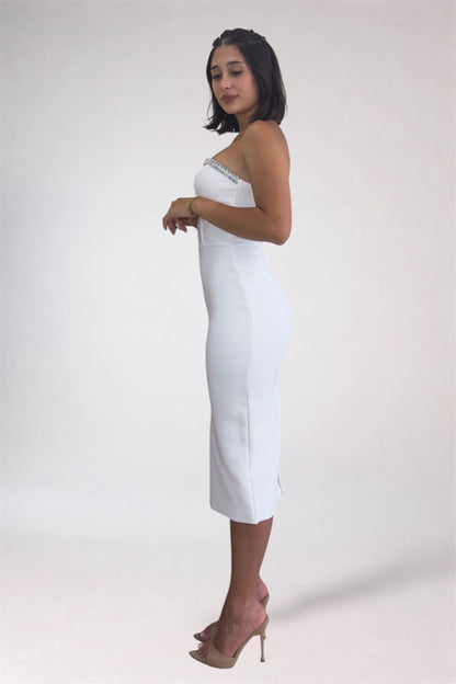 Woman wearing a strapless white dress with a plain background