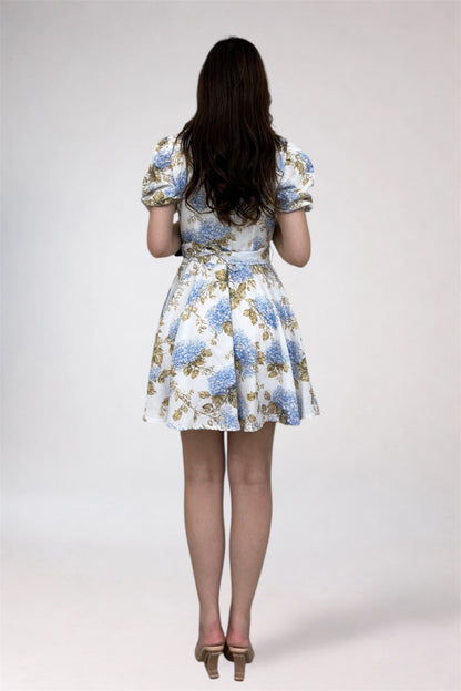 Woman wearing a floral dress on a plain background