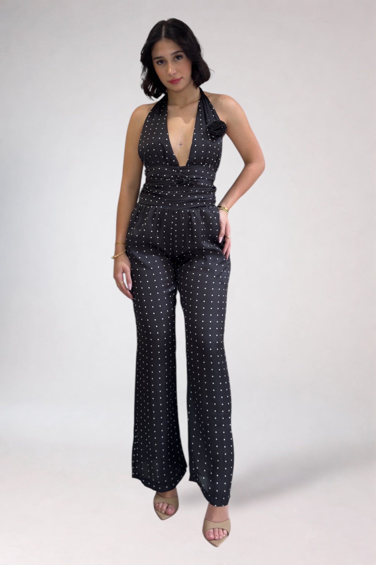 Woman wearing a black patterned jumpsuit on a white background