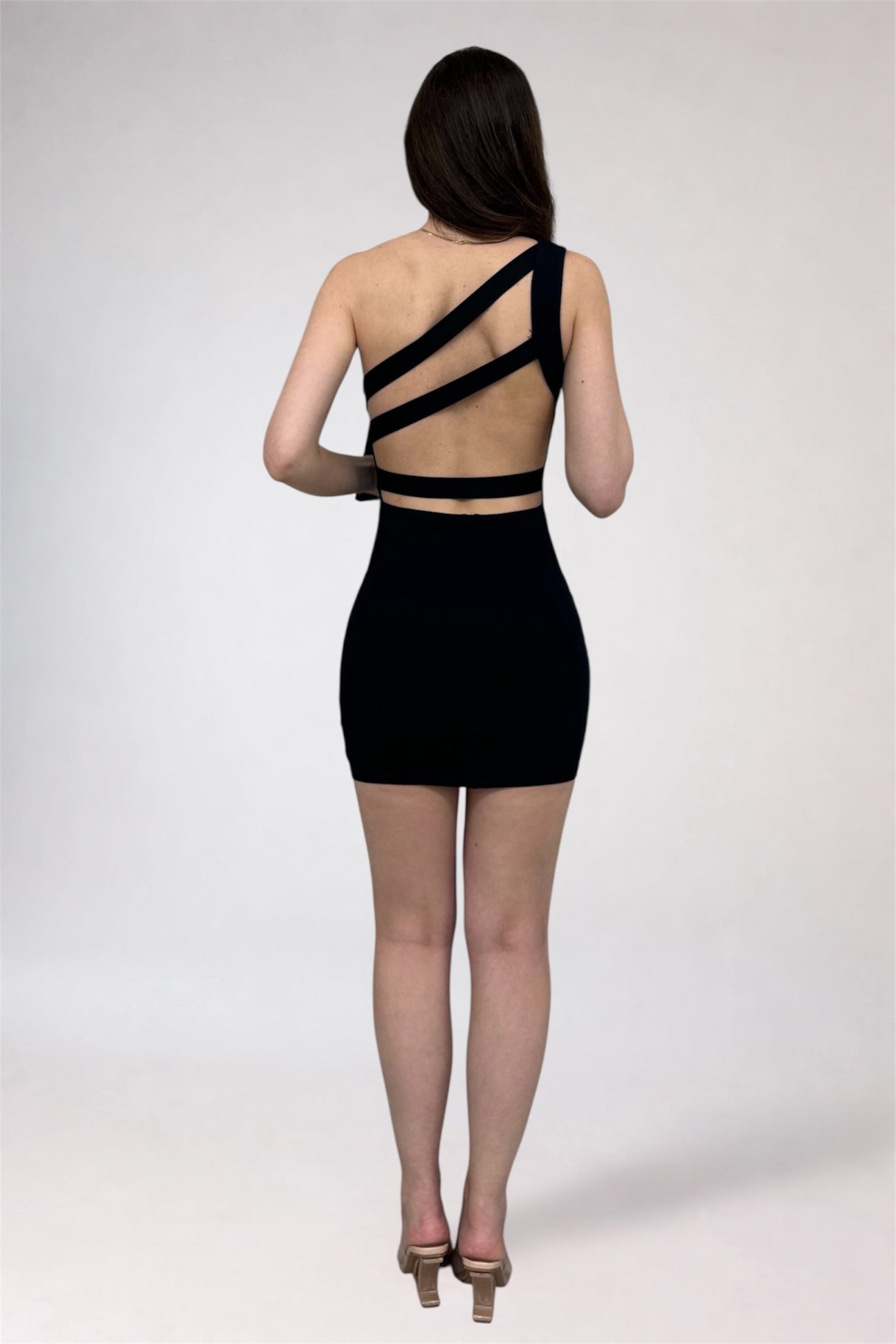Black dress with cut-out back design on a white background