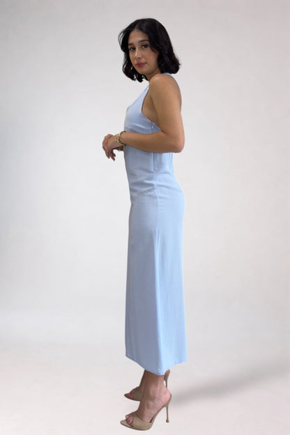 Woman wearing a light blue dress against a white background