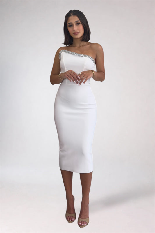 Woman wearing a white one-shoulder dress on a plain background