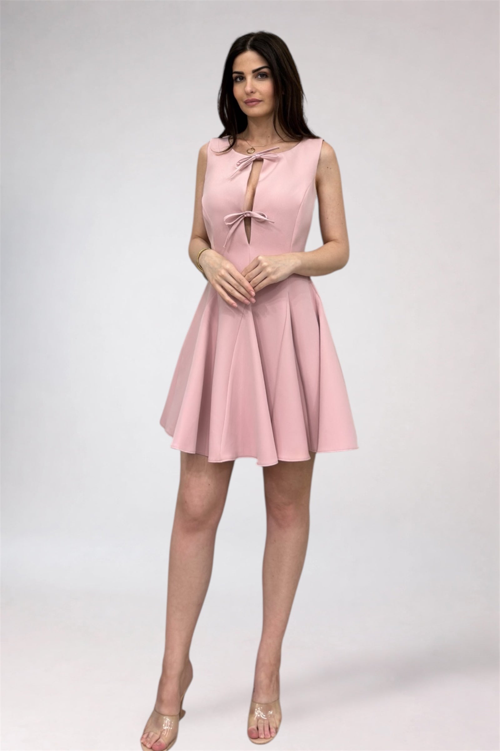 Woman wearing a pink dress on a white background