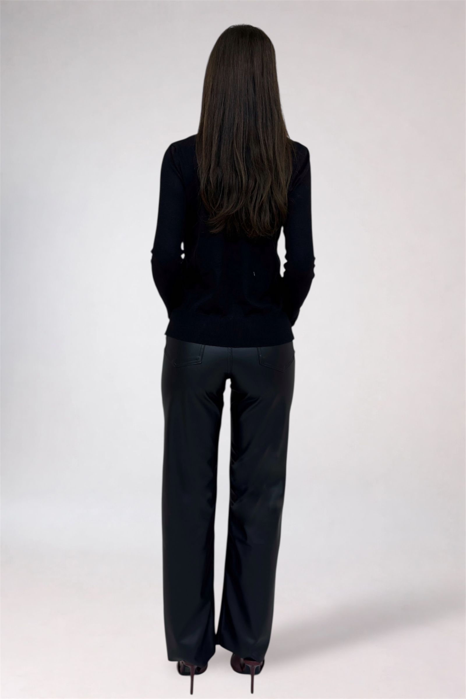 Person wearing a black outfit on a white background