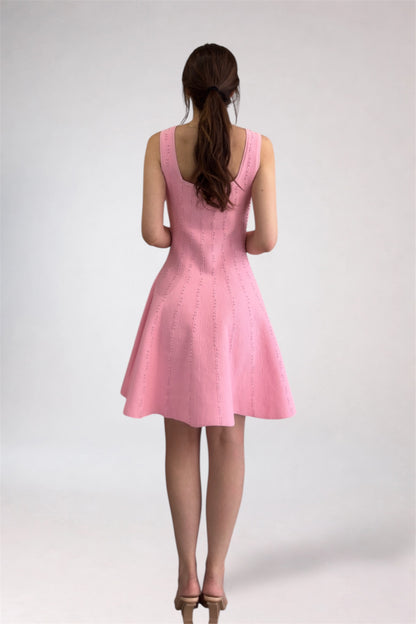 Pink dress worn by a person on a white background