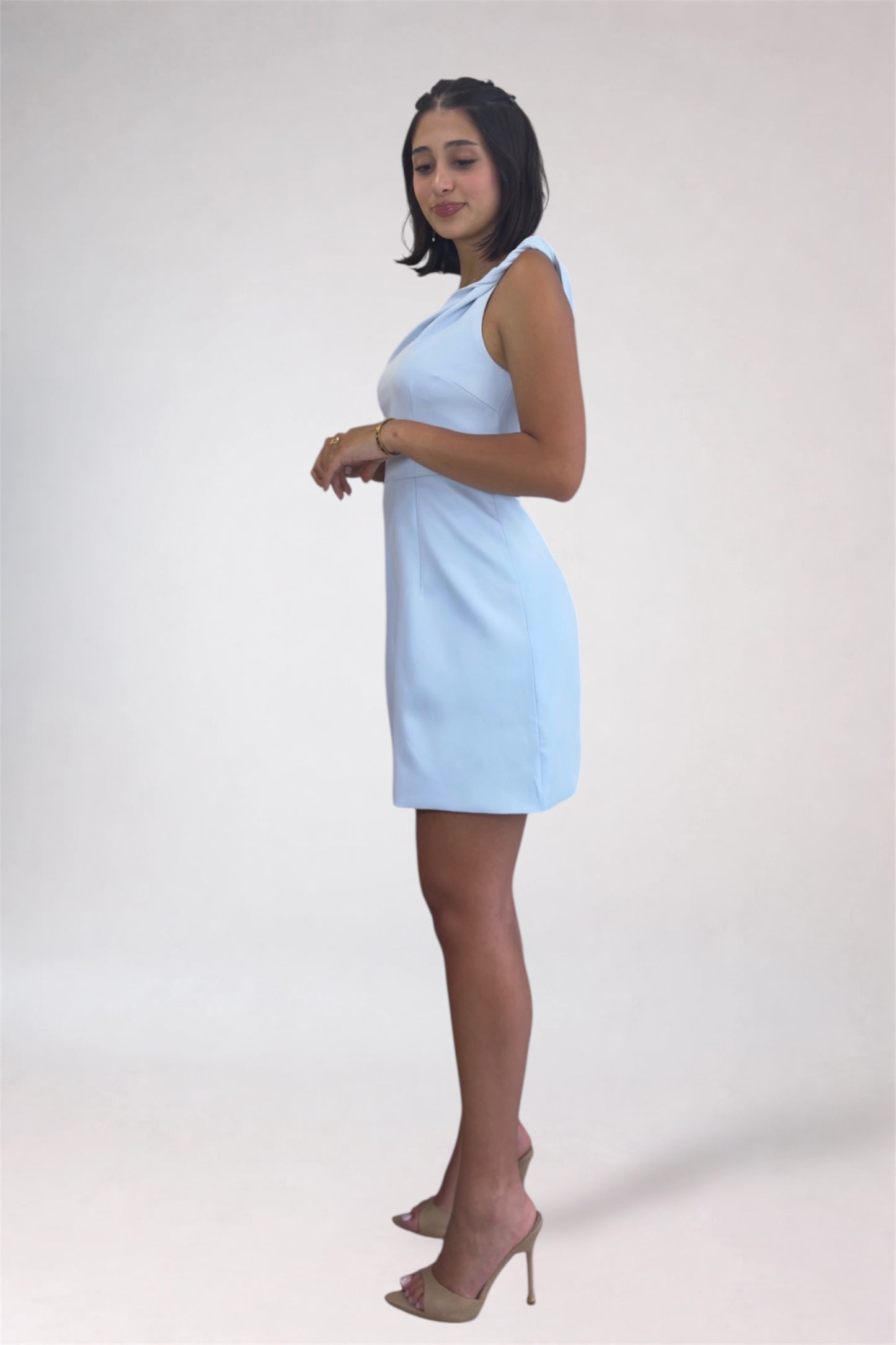 Woman wearing a light blue dress on a white background