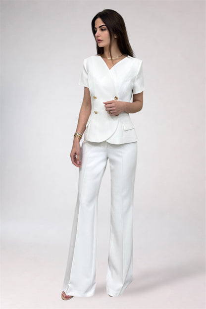 Woman wearing a white suit on a plain background