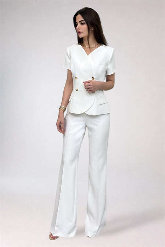 Woman wearing a white suit on a plain background