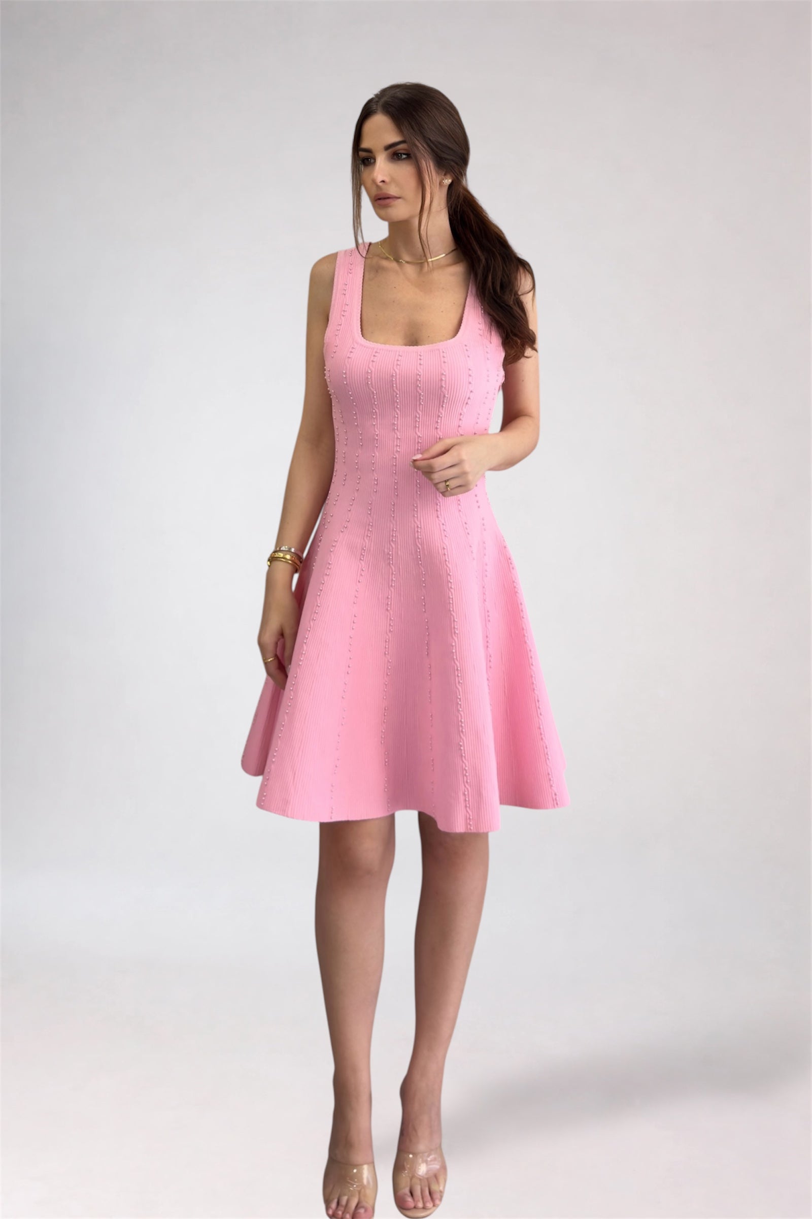 Woman wearing a pink dress on a white background