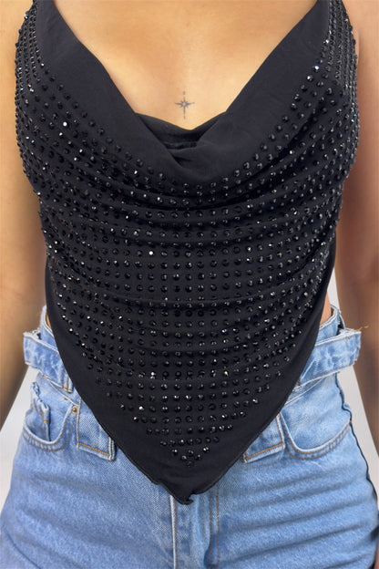 Black embellished top worn by a person with blue jeans