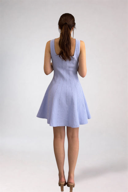 Woman wearing a light blue dress on a white background